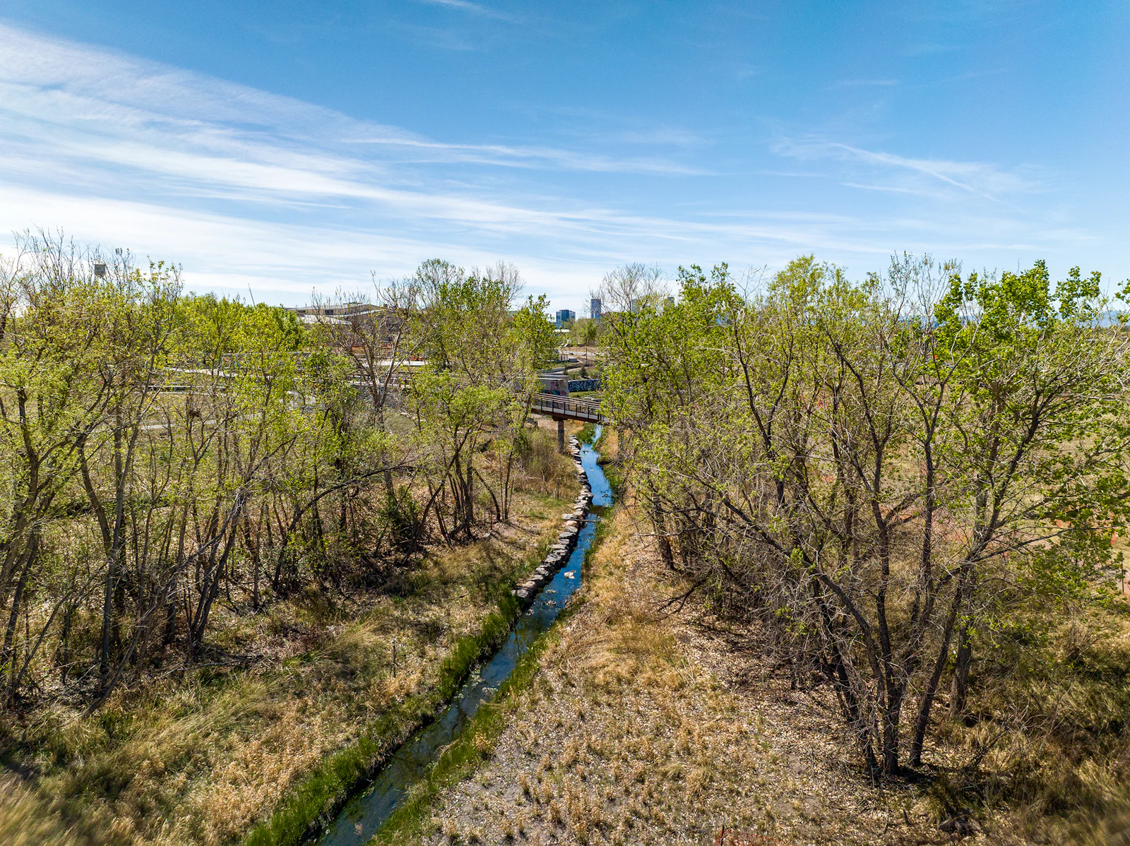 Restored wetlands, riparian corridors, and upland prairie create diverse habitats within the urban fabric.